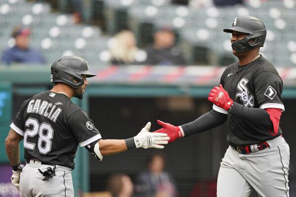 Chicago White Sox's Eloy Jimenez, right, celebrates with Leury Garcia after Jimenez hit a solo home run in the second inning in the first baseball game of a doubleheader against the Cleveland Indians, Thursday, Sept. 23, 2021, in Cleveland. (AP Photo/Tony Dejak)