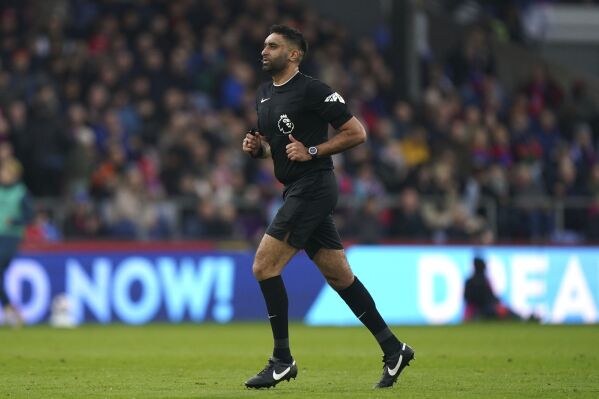 Referee Sunny Gill runs on the pitch, during the English Premier League soccer match between Crystal Palace and Luton Town, at Selhurst Park, in London, Saturday March 9, 2024. (Bradley Collyer/PA via AP)
