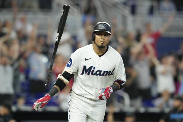 Miami Marlins' Luis Arraez (3) flips his bat after hitting the go ahead run to win the game in the tenth inning of a baseball game against the Colorado Rockies, Sunday, July 23, 2023, in Miami. The Marlins defeated the Rockies 3-2. (AP Photo/Marta Lavandier)