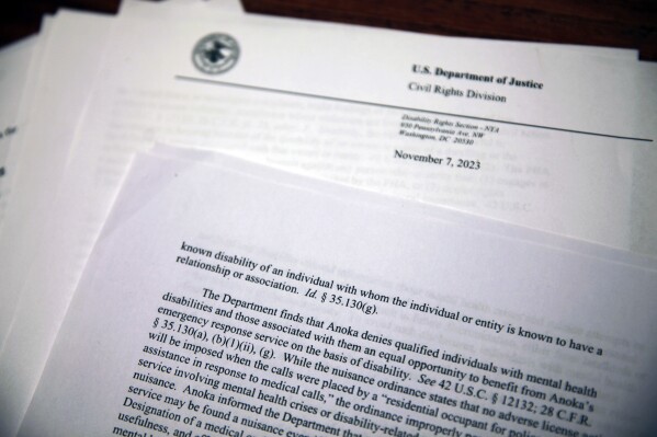 This photo taken Friday, Feb. 2, 2024, shows pages from a letter sent from the U.S. Department of Justice to the Minneapolis suburb of Anoka, Minn. The letter, sent Tuesday, Nov. 7, 2023, details the department's conclusions that the city's enforcement of an ordinance meant to control crime by pressuring landlords to evict troublesome tenants discriminates against people with mental health disabilities. (AP Photo/John Hanna)