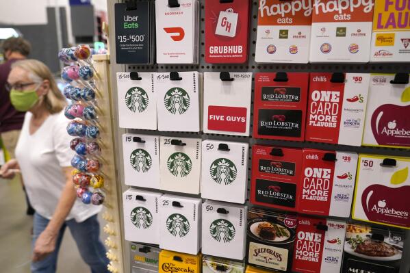 Gift cards for food and beverage businesses sit on display for sale at a retail store in Dallas, Tuesday, Nov. 16, 2021.  The holidays have always been defined by disappointing out-of-stock messages on the most popular items.  Many shoppers will turn to more to gift cards if they don't like what they see. (AP Photo/LM Otero)
