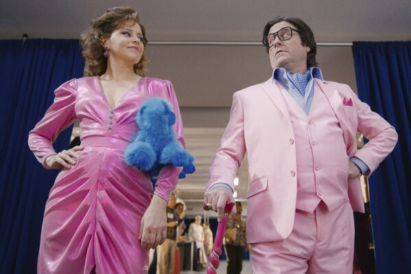 This image released by Apple TV shows Elizabeth Banks, left, and Zach Galifianakis in a scene from 