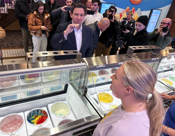 Florida Gov. Ron DeSantis samples praline pecan before ordering a cone at the Blue Bunny Ice Cream Parlor in LeMars, Iowa, Thursday, Jan. 11, 2024. The parlor is a common stop for Republicans when campaigning in northwest Iowa, where social conservatives carry outsize influence in Iowa's Republican caucuses and where DeSantis and Trump are competing aggressively for evangelical conservatives. (AP Photo/Thomas Beaumont)
