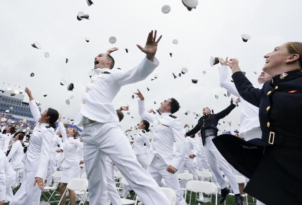 U.S. Naval Academy graduates celebrate and throw their covers at the end of the academy's graduation and commission ceremony in Annapolis, Md., Friday, May 27, 2022. (AP Photo/Manuel Balce Ceneta)