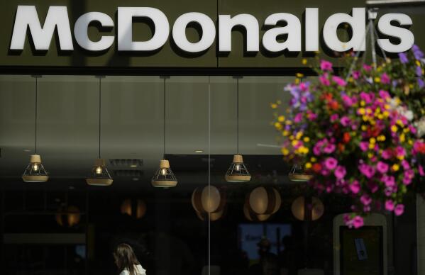 A customer walks in a McDonald's restaurant, in London, Tuesday, Aug. 24, 2021. McDonald’s says it has pulled milkshakes from the menu in all 1,250 of its British restaurants because of supply problems stemming from a shortage of truck drivers. The fast-food chain says it is also experiencing shortages of bottled drinks. (AP Photo/Alastair Grant)