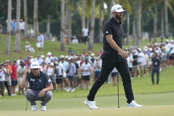 Cameron Smith, left, and Dustin Johnson, right, line up their shots on the second green during the final round of the LIV Golf Team Championship at Trump National Doral Golf Club, Sunday, Oct. 30, 2022, in Doral, Fla. (AP Photo/Lynne Sladky)