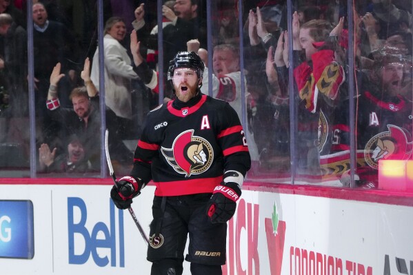 Ottawa Senators right wing Claude Giroux (28) celebrates his game-winning goal in overtime against the Nashville Predators during an NHL hockey game in Ottawa, Ontario, Monday, Jan. 29, 2024. (Sean Kilpatrick/The Canadian Press via AP)