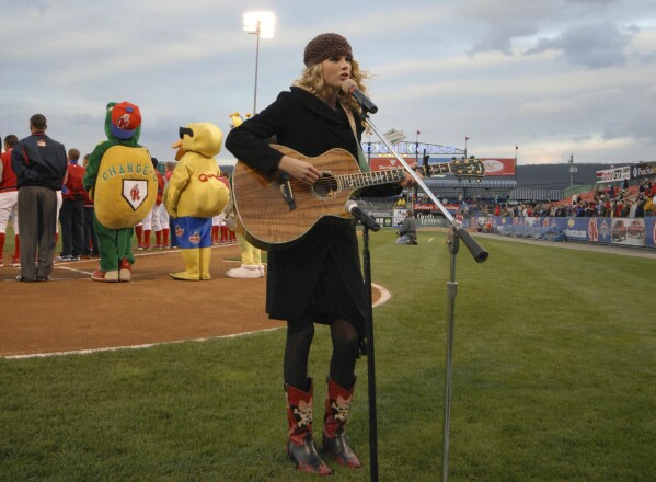 This photo provided by the Reading Fightin Phils shows Taylor Swift singing the national anthem before a Reading Fightin Phils minor league baseball game at First Energy Stadium in Reading, Pa., April 5, 2007. Taylor Swift got her singing career started by performing the national anthem at sporting events as a young child and teenager. (Reading Fightin Phils via AP)