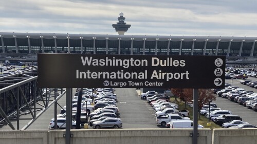 FILE - The Metrorail station at Dulles International Airport is seen on Nov. 2, 2022, in Chantilly, Va., with the terminal in the background. Normal operations at airports in the Washington, D.C., area resumed about an hour after they were suspended Sunday evening, June 25, 2023, because of a problem at a major air traffic control facility, the Federal Aviation Administration said. (AP Photo/Matthew Barakat, File)