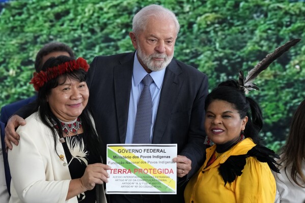 Brazil's President Luiz Inacio Lula da Silva, holds a plaque demarcating Indigenous Lands, next to the President of the National Indigenous Foundation Joenia Wapichana, left, and the Minister of Indigenous Peoples Sonia Guajajara, during during ceremony to commemorate Amazon Day, in Brasilia, Brazil, Tuesday, Sept. 5, 2023. (AP Photo/Eraldo Peres)