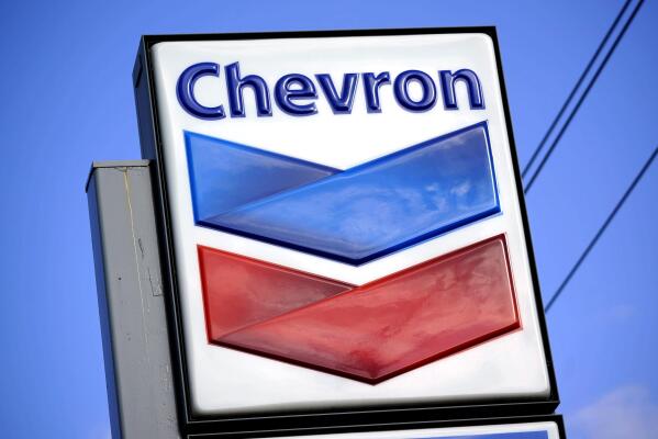FILE - A Chevron sign is displayed outside one of the company's gas stations in Bradenton, Fla., Feb. 22, 2022. The Biden administration is easing some oil sanctions on Venezuela in an effort to support newly restarted negotiations between the Venezuelan government and its opposition. The Treasury Department is allowing Chevron to resume “limited” energy production in Venezuela after years of sanctions that have dramatically curtailed oil and gas profits that have flowed to President Nicolás Maduro’s government. (AP Photo/Gene J. Puskar, File)