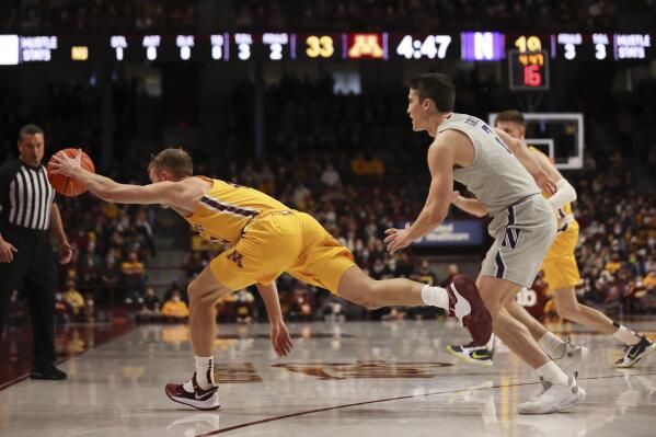 Minnesota guard Luke Loewe (12) reaches to keep the ball in bounds against Northwestern guard Ryan Greer (2) during the first half of an NCAA college basketball game Saturday, Feb. 19, 2022, in Minneapolis. (AP Photo/Stacy Bengs)
