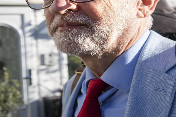 Britain's former opposition Labour Party leader Jeremy Corbyn leaves his home in London, Wednesday Nov. 18, 2020.  Corbyn will be reinstated into the political party it is announced Wednesday after a three-week suspension as Labour’s National Executive Committee seeks to draw a line under years of tumultuous divisions over alleged anti-Jewish prejudice in the party. (Aaron Chown/PA via AP)