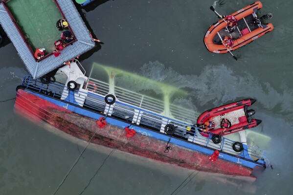 In this photo released by Xinhua News Agency, rescuers conduct a search and rescue operation at one of the two passenger boats capsized in Qianxi City, southwest China's Guizhou Province on Monday, May 5, 2025. (Liu Xu/Xinhua via AP)