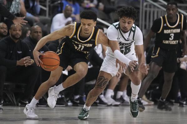 Northern Kentucky's Xavier Rhodes (11) is defended by Cleveland State's Drew Lowder (55) during the first half of an NCAA college basketball game for the Horizon League men's tournament championship Tuesday, March 7, 2023, in Indianapolis. (AP Photo/Darron Cummings)