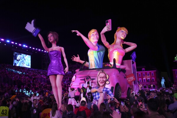 A carnival float depicting Barbie parades through Place Massena during the opening ceremony of 151st edition of the Nice Carnival in Nice, southern France, Saturday, Feb. 17, 2024. (AP Photo/Daniel Cole)
