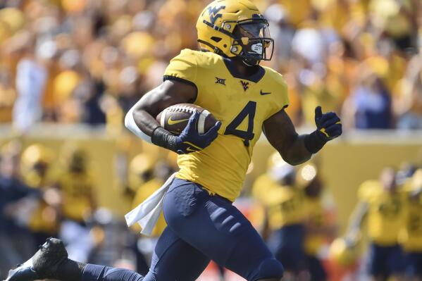 West Virginia running back Leddie Brown (4) rushes for a touchdown against Virginia Tech during the first half of an NCAA college football game in Morgantown, W.Va., Saturday, Sep. 18, 2021. (AP Photo/William Wotring)