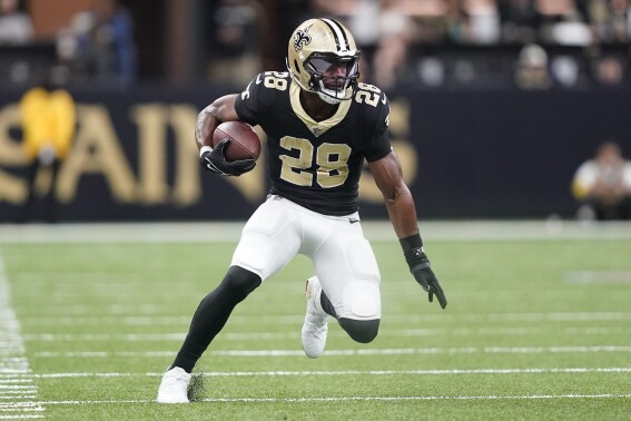 FILE - New Orleans Saints running back David Johnson runs during the first half an NFL football game against the Carolina Panthers in New Orleans, Jan. 8, 2023. Johnson says he's retiring from the NFL after eight seasons. The 32-year-old made the announcement on Instagram Sunday, May 19, 2024. (AP Photo/Gerald Herbert, File)