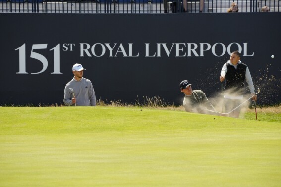 Denmarks Nicolai Hojgaard, left, and his identical twin brother Rasmus Hojgaard on the 19th green during a practice round for the British Open Golf Championships at the Royal Liverpool Golf Club in Hoylake, England, Wednesday, July 19, 2023. The Open starts Thursday, July 20. (AP Photo/Jon Super)