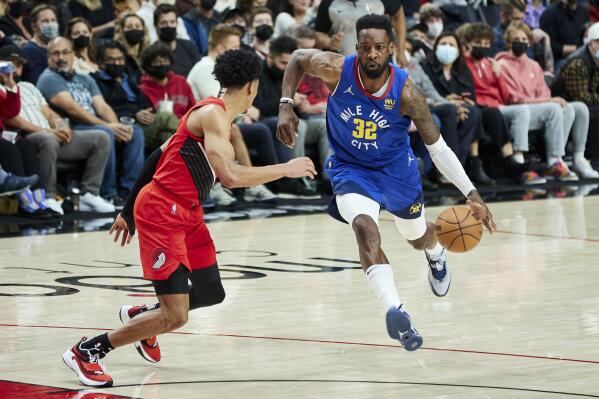 Denver Nuggets forward Jeff Green, right, dribbles toward Portland Trail Blazers guard Anfernee Simons during the first half of an NBA basketball game in Portland, Ore., Sunday, Feb. 27, 2022. (AP Photo/Craig Mitchelldyer)