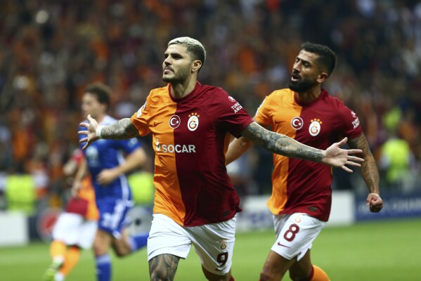 Galatasaray's Mauro Icardi, left, celebrates scoring with teammate Kerem Demirbay during the Champions League soccer match between Galatasaray and Molde in Istanbul, Turkey, Tuesday, Aug. 29, 2023. (dia images via AP)
