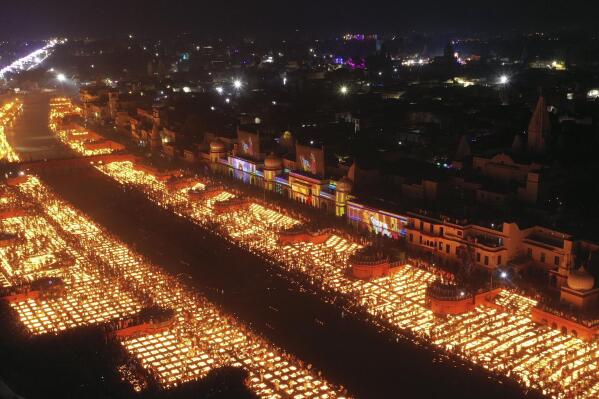 People light lamps on the banks of the river Saryu in Ayodhya, India, Wednesday, Nov. 3, 2021. Millions of people across Asia are celebrating the Hindu festival of Diwali, which symbolizes new beginnings and the triumph of good over evil and light over darkness. The celebrations were especially spectacular in Ayodhya city in northern Uttar Pradesh state, where over 900,000 earthen lamps were lit at the banks of the Saryu River as desk fell Wednesday. Hindus believe the city is the birthplace of god Ram. (AP Photo/Rajesh Kumar Singh)