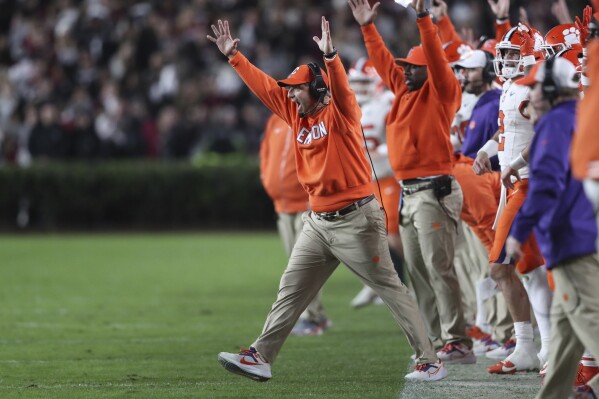 Clemson head coach Dabo Swinney celebrates a 50-yard field goal by place-kicker Jonathan Weitz during the first half of the team's NCAA college football game against South Carolina, Saturday, Nov. 25, 2023, in Columbia, S.C. (AP Photo/Artie Walker Jr.)