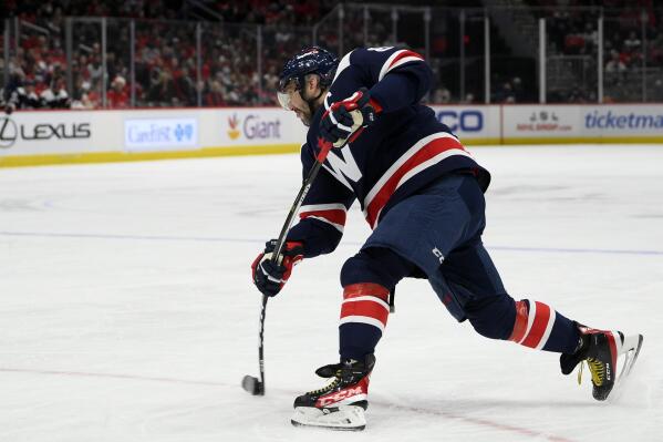 Washington Capitals left wing Alex Ovechkin (8) shoots the puck during the first period of an NHL hockey game against the Columbus Blue Jackets, Saturday, Dec. 4, 2021, in Washington. (AP Photo/Nick Wass)