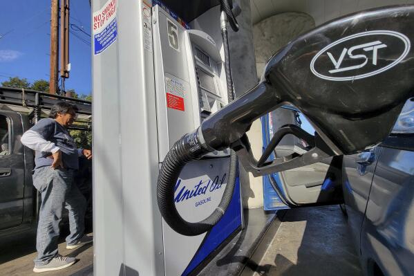 A motorist pumps gasoline at United Oil gas station in Los Angeles Friday, Aug. 12, 2022. The average U.S. price of regular-grade gasoline plummeted 45 cents over the past two weeks to $4.10 per gallon. Industry analyst Trilby Lundberg of the Lundberg Survey said Sunday, Aug. 14, 2022, that the continued decline comes as crude oil costs also remain low. (AP Photo/Damian Dovarganes)