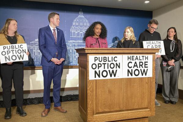 Home health care worker Tavona Johnson, whose husband was diagnosed with advanced colon cancer, speaks at a news conference at the Capitol in St. Paul, Minn, on Wednesday, Feb. 8, 2023, in support of a Democratic proposal to allow all residents to buy into the state-run MinnesotaCare health insurance program. (AP Photo/Steve Karnowski)