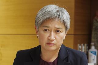 FILE - Australian Foreign Minister Penny Wong talks to New Zealand Foreign Minister Nanaia Mahuta at a bilateral meeting in Wellington, New Zealand on June 16, 2022. Wong on Tuesday, July 12, 2022 urged Pacific island neighbors to unite on their shared challenges of U.S.-China strategic competition, climate change and COVID-19. (Robert Kitchin/Pool Photo via AP, File)