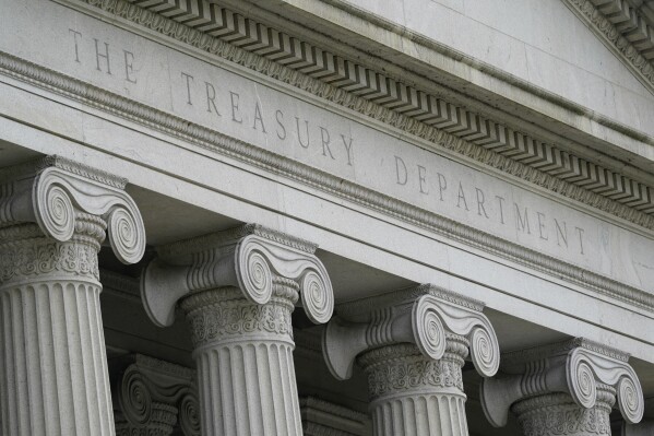 FILE - The Treasury Building is viewed in Washington on May 4, 2021. The Biden administration hit hundreds of people and firms, from Russia to China to Turkey and the United Arab Emirates, with economic and diplomatic sanctions Tuesday, Dec. 12, 2023, as the U.S. targets third-country contributors that are equipping Russia's invasion of Ukraine. (AP Photo/Patrick Semansky, File)