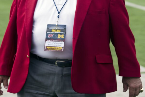 FILE - Wisconsin athletic director Barry Alvarez is shown on the field before an NCAA college football game against Michigan at Michigan Stadium in Ann Arbor, Mich., in this Saturday, Oct. 1, 2016, file photo. Wisconsin athletic director Barry Alvarez is retiring after a three-decade run in which he transformed the university’s football program and later guided the Badgers to their greatest all-around sports success in the school’s history. Alvarez announced Tuesday, April 6, 2021, he would retire on June 30.(AP Photo/Tony Ding, File)