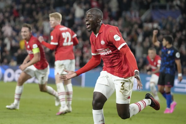 PSV's Jordan Teze celebrates after scoring his side's second goal during the Group B Champions League soccer match between PSV and Sevilla at Philips stadium in Eindhoven, Netherlands, Tuesday, Oct. 3, 2023. (AP Photo/Peter Dejong)