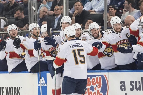 Florida Panthers' Anton Lundell (15) celebrates with teammates after scoring a goal against the New York Rangers during the third period of Game 5 in the Eastern Conference finals of the NHL hockey Stanley Cup playoffs Thursday, May 30, 2024, in New York, N.Y. The Panthers won 3-2. (AP Photo/Frank Franklin II)