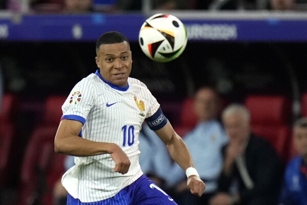 FILE - Kylian Mbappe of France controls the ball during a Neighborhood D match between Austria and France on the Euro 2024 soccer occasion in Duesseldorf, Germany, Monday, June 17, 2024. (AP Photo/Alessandra Tarantino, File)