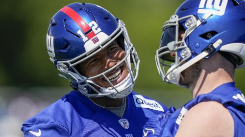 New York Giants tight ends Darren Waller, left, and Daniel Bellinger, right, laugh on the sidelines of practice at the NFL football team's practice facility, Thursday, May 25, 2023, in East Rutherford, N.J. (AP Photo/John Minchillo)
