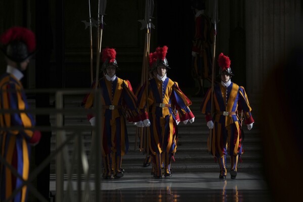 Vatican Swiss Guards stand in the atrium of St. Peter's Basilica at the Vatican before the body of Pope Francis will be carried inside where he will lie in state for three days, Wednesday, April 23, 2025. (AP Photo/Andrew Medichini, Pool)