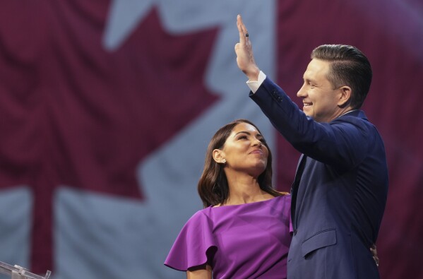 Conservative Leader Pierre Poilievre and his wife Anaida at his campaign headquarters on election night, in Ottawa, Tuesday, April 29, 2025. (Christinne Muschi/The Canadian Press via AP)