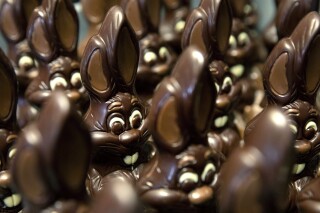 FILE - Chocolate rabbits wait to be decorated at the Cocoatree chocolate shop, April 8, 2020, in Lonzee, Belgium. Sweet Easter baskets will likely come at a bitter cost this year for consumers as the price of cocoa climbs to record highs. (AP Photo/Virginia Mayo, File)
