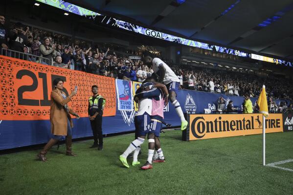 Vancouver Whitecaps' Pedro Vite, Cristian Dajome and Leonard Owusu , from left, celebrate Vite's goal against the LA Galaxy during the second half of an MLS soccer match Wednesday, Sept. 14, 2022, in Vancouver, British Columbia. (Darryl Dyck/The Canadian Press via AP)