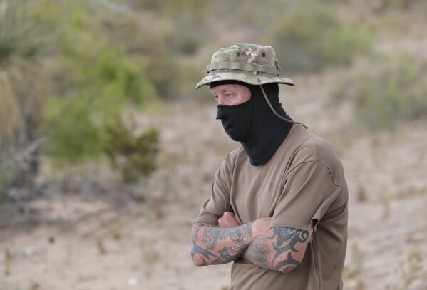 
              "Viper," a member of the United Constitutional Patriots stands dejected after Union Pacific Police evicted the group from their camp in Anapra, N.M., Tuesday, April, 23, 2019. The group was camping on Union Pacific land. (Mark Lambie/The El Paso Times via AP)
            