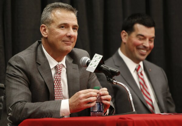 
              Ohio State NCAA college football head coach Urban Meyer, left, answers questions during a news conference announcing his retirement Tuesday, Dec. 4, 2018, in Columbus, Ohio. At right is assistant coach Ryan Day. (AP Photo/Jay LaPrete)
            