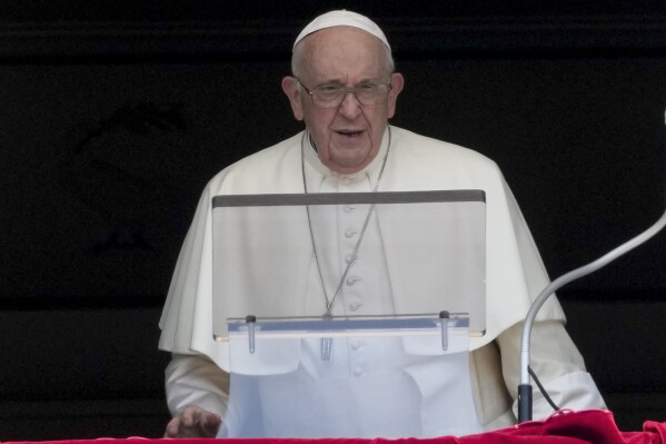 Pope Francis delivers his blessing as he recites the Angelus noon prayer from the window of his studio overlooking St.Peter's Square, at the Vatican, Sunday, Aug. 20, 2023. (AP Photo/Andrew Medichini)