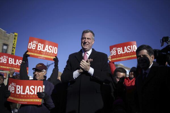 FILE - Democratic New York City mayoral candidate Bill de Blasio campaigns at a subway stop in New York, Monday, Nov. 4, 2013. De Blasio swept into the New York City mayor's office eight years ago promising a liberal remolding of the nation's largest city that would level deep inequities and reform police practices. (AP Photo/Seth Wenig, File)