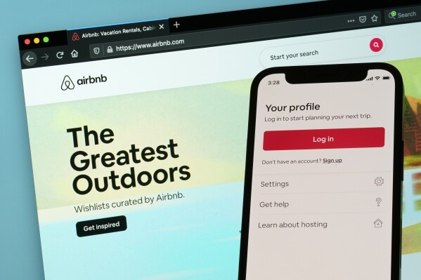 FILE - The login page for Airbnb's iPhone app is displayed on a computer displaying Airbnb's website, May 8, 2021, in Washington. Airbnb said Thursday, Aug. 3, 2023, that its second-quarter profit jumped more than 70% over last summer, to $650 million, as revenue rose on strong bookings for summer-vacation rentals. (AP Photo/Patrick Semansky, File)