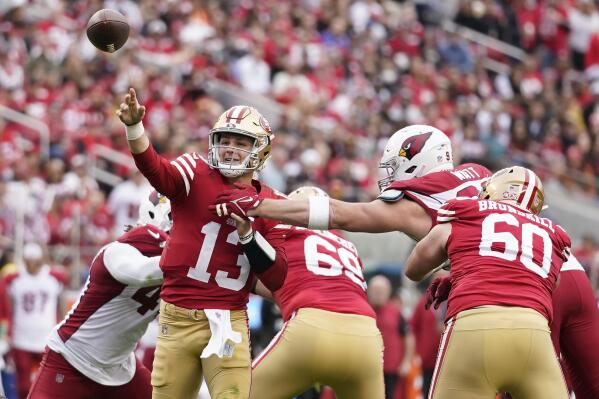 San Francisco 49ers quarterback Brock Purdy (13) throws a touchdown pass during the first half of an NFL football game against the Arizona Cardinals in Santa Clara, Calif., Sunday, Jan. 8, 2023. (AP Photo/Godofredo A. Vásquez)