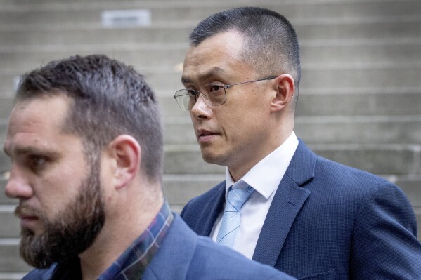 File - Binance founder and CEO Changpeng Zhao, right, leaves federal court in Seattle on Nov. 21, 2023, after pleading guilty to violations of U.S. anti-money laundering laws. Bitcoin's current rally also arrives during an incredibly disruptive period for cryptocurrencies. Just last month, the U.S. government slapped Binance, the world's largest crypto exchange, with a $4 billion fine as its founder Changpeng Zhao pleaded guilty to a felony charge. (Ken Lambert/The Seattle Times via AP, File)