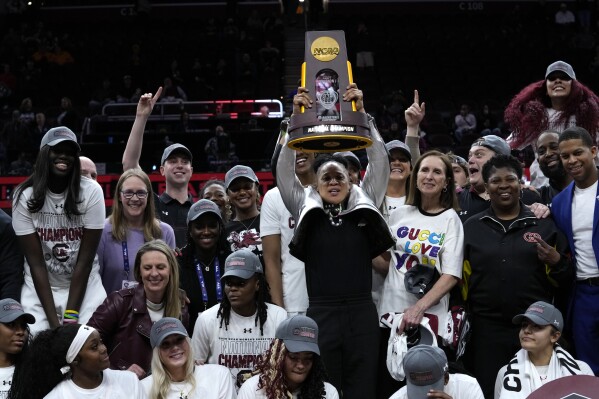 South Carolina head coach Dawn Staley celebrates with her team after the Final Four college basketball championship game against Iowa in the women's NCAA Tournament, Sunday, April 7, 2024, in Cleveland. South Carolina won 87-75. (AP Photo/Carolyn Kaster)