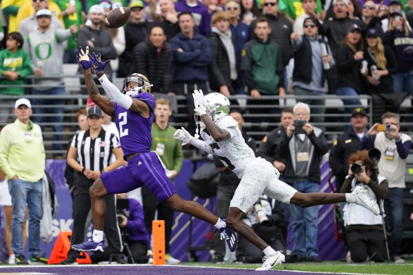 Washington wide receiver Ja'Lynn Polk (2) makes a touchdown catch against Oregon defensive back Khyree Jackson, right, during the first half of an NCAA college football game, Saturday, Oct. 14, 2023, in Seattle. (AP Photo/Lindsey Wasson)